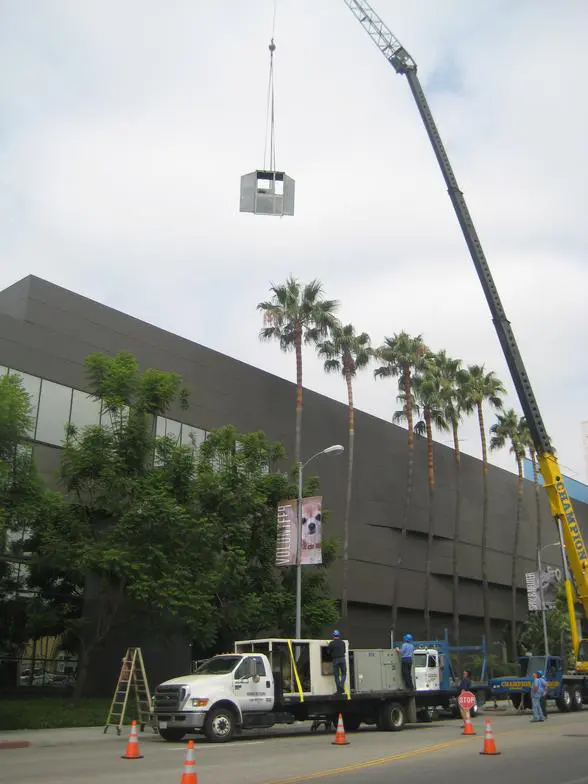 A crane is lifting a camera from the ground.