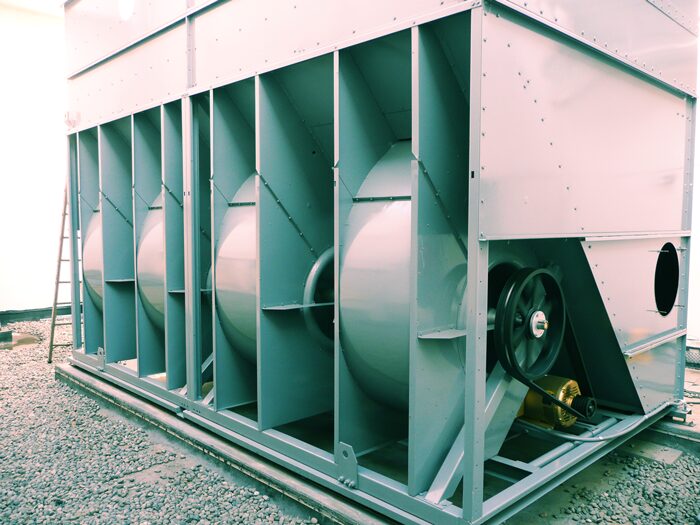A large industrial fan is sitting on the ground.